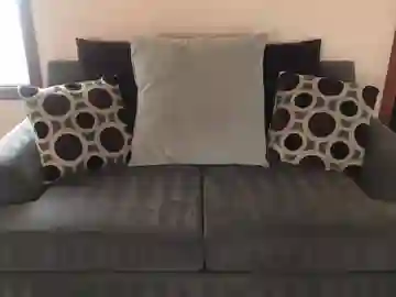 qt=q_11 (2) A couch with several pillows on it.